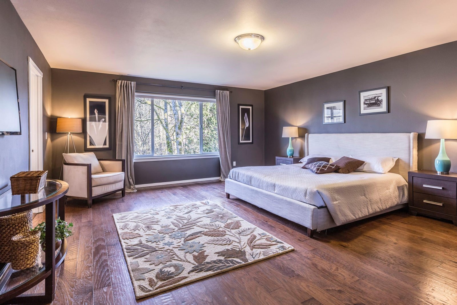 A bedroom in a two story home with beautiful wood flooring.